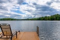 Dock and Chair on a Northwoods Lake Royalty Free Stock Photo