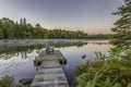 Dock and Chairs on a Lake at Sunset Royalty Free Stock Photo