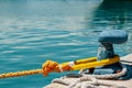 Dock, deck cleat, securing a heavy, braided, yellow line