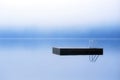 Dock floating on misty lake