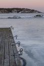 the dock is sitting on ice and the water is frozen Royalty Free Stock Photo