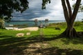 Dock with hammocks along the lake shore with dark blue cloudscape, El Remate, Peten, Guatemala Royalty Free Stock Photo