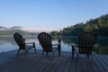 Adirondack Chairs on a Dock on a lake in the early morning Royalty Free Stock Photo