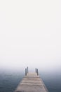 Dock on the lake in the fog during summer Royalty Free Stock Photo
