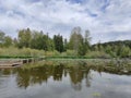 Dock, lilly pads, fishing, lake,clouds Royalty Free Stock Photo