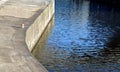 Dock at the lock for the addition of river cargo ships. metal bollards for mooring steel ropes on the navigation channel. waterfro Royalty Free Stock Photo