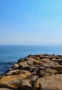 Dock made of rocks and the open sea. Royalty Free Stock Photo