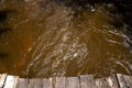 a dock in the middle of some muddy water that is brown Royalty Free Stock Photo