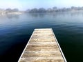 Dock overlooking calm fog over the river Royalty Free Stock Photo