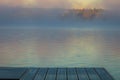 A dock overlooks a calm lake as the morning fog lifts in early autumn at Silver Lake, Castile, NY Royalty Free Stock Photo