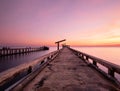 Dock pier jetty concreate bridge to the sea in sunset twilight sky. Royalty Free Stock Photo