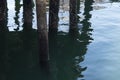Dock pilons reflected in the water of puget sound