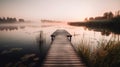 a dock sitting on top of a lake next to a forest filled with lots of water lilies and reeds in the foggy water Royalty Free Stock Photo