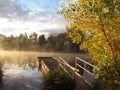 Dock on sunrise foggy lake Royalty Free Stock Photo