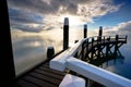 Dock in the Wadden Sea with a cloudy sky over it Royalty Free Stock Photo