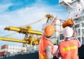 Dock worker pointing finger on control of container loading