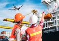 Dock worker pointing finger on control of container loading in a Royalty Free Stock Photo