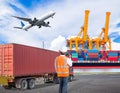 Dock worker talking on the walkie-talkie for controlling loading