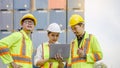 Dock workers communicate with the supervisor, recording data online using a laptop at a warehouse Royalty Free Stock Photo
