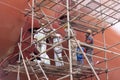 Dock yard, shipyard employees are working near the big container vessel hull. Royalty Free Stock Photo