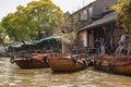 Docked boats and waiting people at canal in Tongli, China