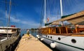 Docked ship in port. Docking on the pier in the Mediterranean. Yacht parked at dock. Tourist with backpack walking on the pier