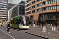 Docklands, Australia - September 25th 2018: Tram riding down Collins Street, Docklands, towards Victoria Harbour.