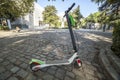 Dockless electric kick scooters from a scooter-sharing system parked on a sidewalk