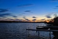 Sunset over large lake and docks jutting into water located in Hayward, Wisconsin Royalty Free Stock Photo