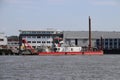 Docks with ships and cranes along the riverside of the river Lek or Noord in the Netherlands.