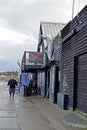 A dockyard worker walking past the fish mongers.