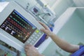 Doctor adjusting heart monitor connected to the severe patient in the intensive care unit Royalty Free Stock Photo