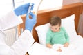 Doctor adjusting intravenous drip for little child in hospital