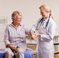 Doctor adjusting senior woman wrist splint Royalty Free Stock Photo