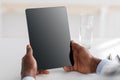 Doctor advice and technology for treat. African american doctor using digital tablet with black blank screen, mockup for