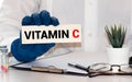 Doctor advises. Nutritionist or medical worker holds a VITAMIN C sign, healthy lifestyle concept