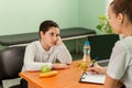 Doctor advising a fat boy to eat healthy. Obesity, health problem Royalty Free Stock Photo