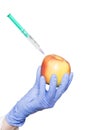 Doctor aesthetician makes beauty injections to apple on isolated background