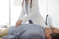 Doctor analyzing abdomen of patient in examination room at hospital Royalty Free Stock Photo