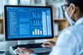 Doctor Analyzing Patient Data on Computer Screen with Clinical Spreadsheet and Medical Charts Royalty Free Stock Photo