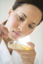 Doctor Analyzing Solution In Petri Dish At Laboratory