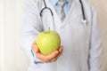 Doctor with apple and stethoscope, close up Royalty Free Stock Photo