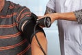 Doctor applies cuff for blood pressure measurement Royalty Free Stock Photo