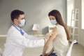 Doctor applies the patch to the patient& x27;s arm after injecting her with a seasonal flu. Royalty Free Stock Photo