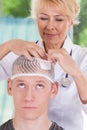 Doctor applying dressing after head injury