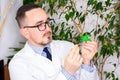 Doctor at appointment or scientist microbiologist virologist shows model of microorganism - virus prion or bacteria. Demonstration