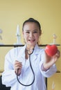 Doctor asian female hands holding stethoscope and heart red model,Happy and smiling,Selective focus Royalty Free Stock Photo