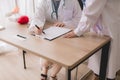 Doctor asian women sitting and writing note at hospital,Female working together,Copy space for text Royalty Free Stock Photo