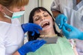 Doctor and assistant comparing patient`s teeth with sampler Royalty Free Stock Photo