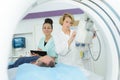 Doctor assistant and patient in mri room at hospital